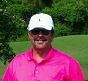 A person in a pink shirt and white hat

Description automatically generated